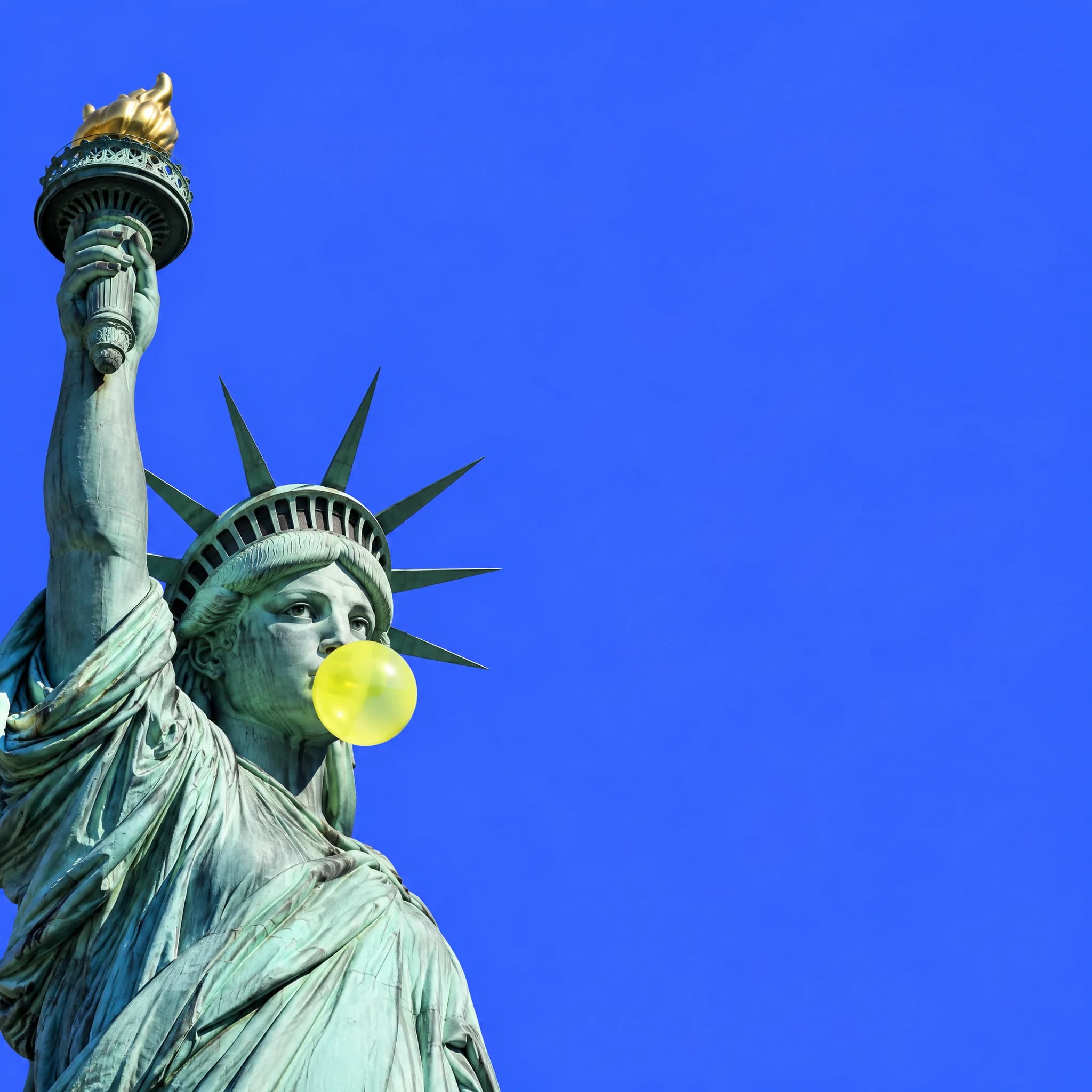 Statue of Liberty blowing a lime bubble-gum bubble against a blue sky